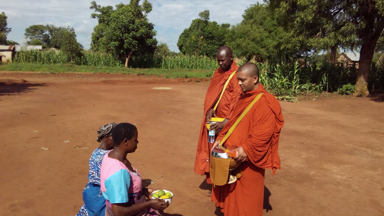 For first time, alms round of Buddhist monks in Uganda, Africa.