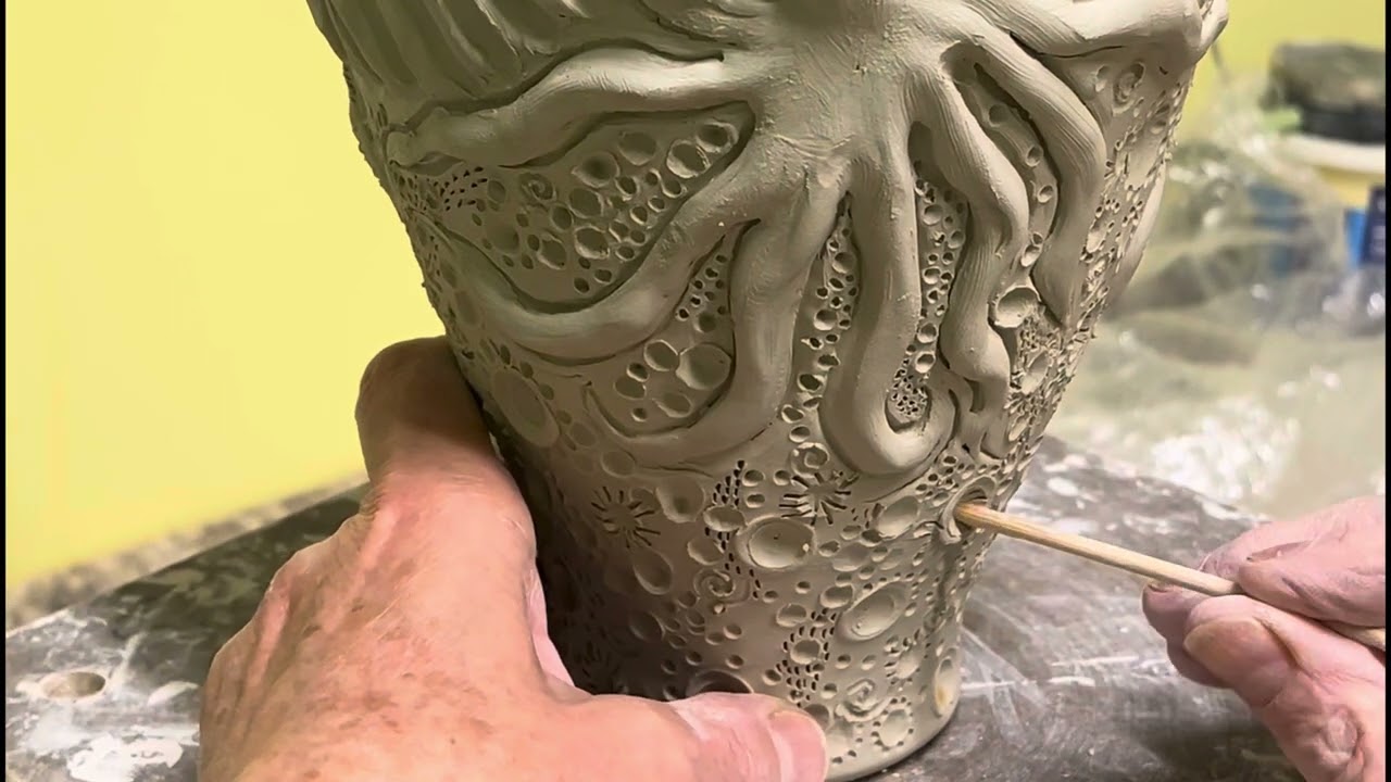 Texturing a wheel thrown and embellished pottery vase.