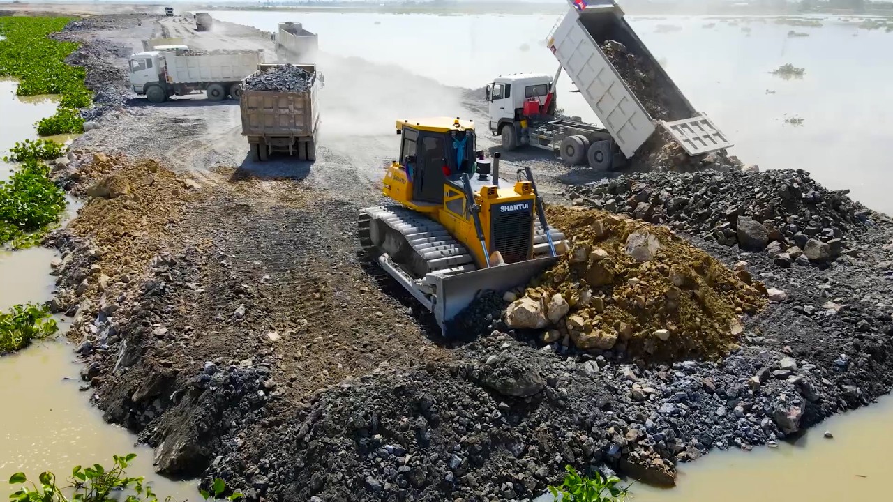 Look Out!! Processing Filling Stone Close to the Border Using Bulldozer and Dump Truck in Operation