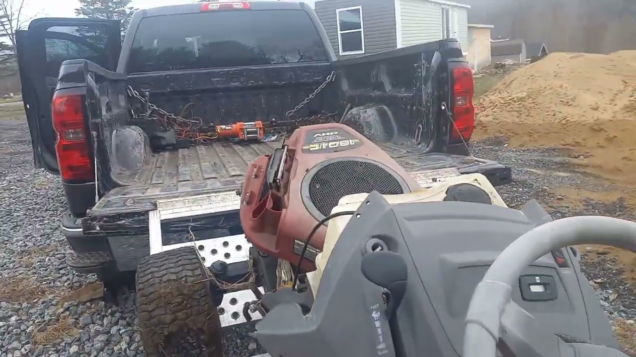 Loading dead riding lawnmower on a small truck
