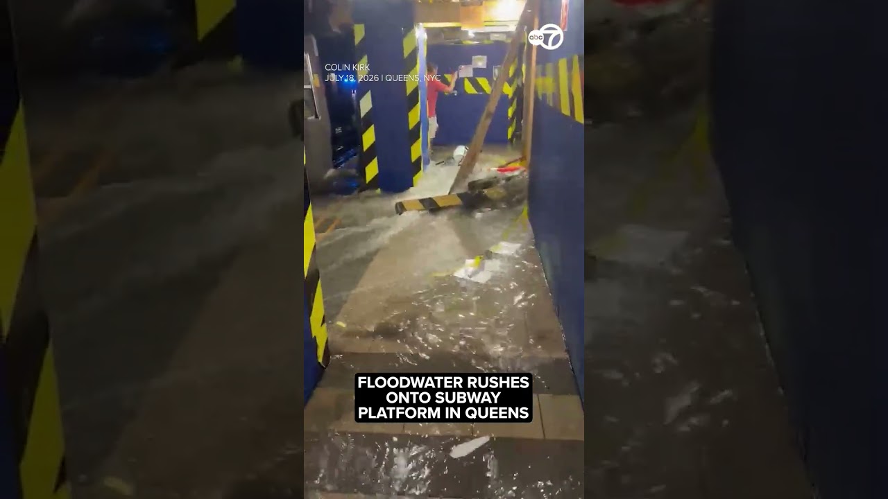 Driver wades through waist high floodwater after vehicle gets stuck