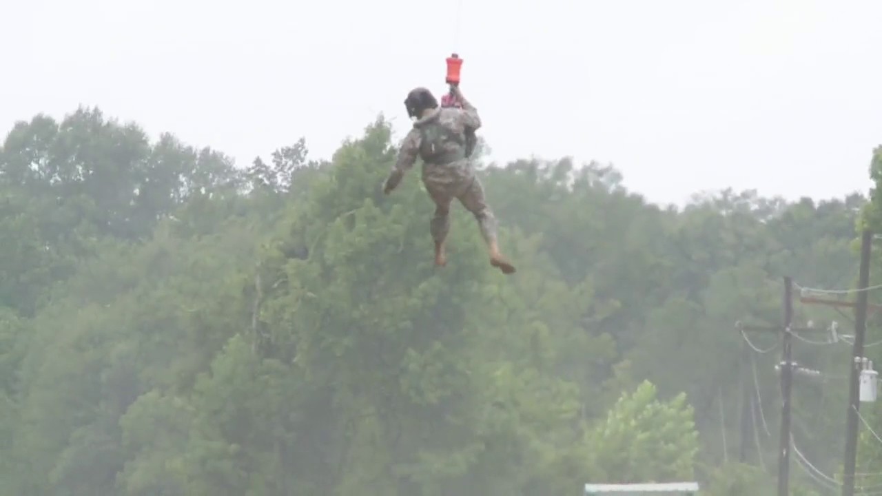 National Guard rescues motorist stranded amid rushing waters.