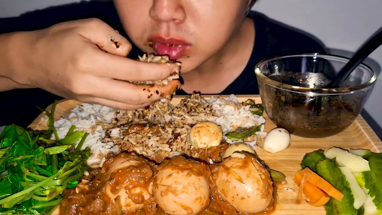 Eating Boiled Eggs Curry with Rice, Fish Paste, Fresh Vegetable.