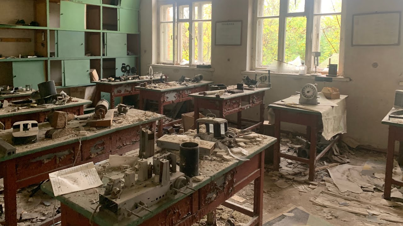 Exploring abandoned villages near Belarus in Chernobyl exclusion zone. Houses, schools, church.