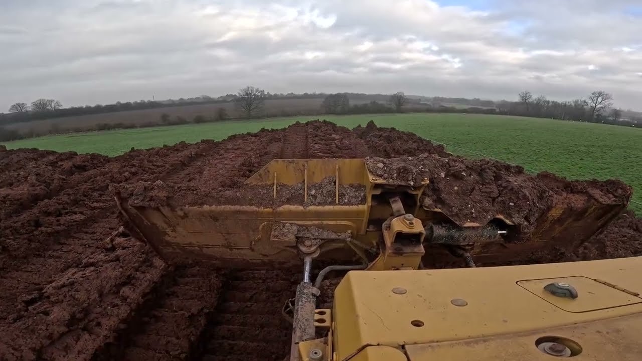 CAT D6 Cab POV working a stockpile