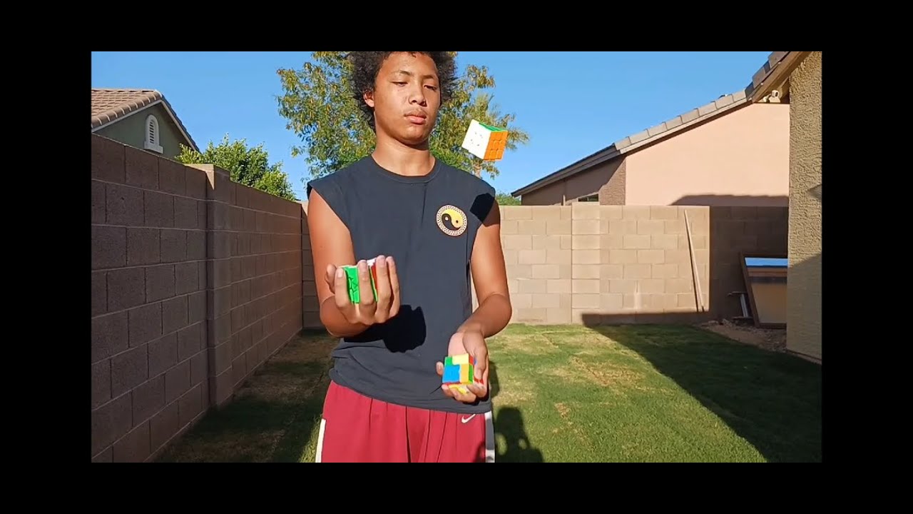 HE SOLVES 3 RUBIK'S CUBES WHILE JUGGLING
