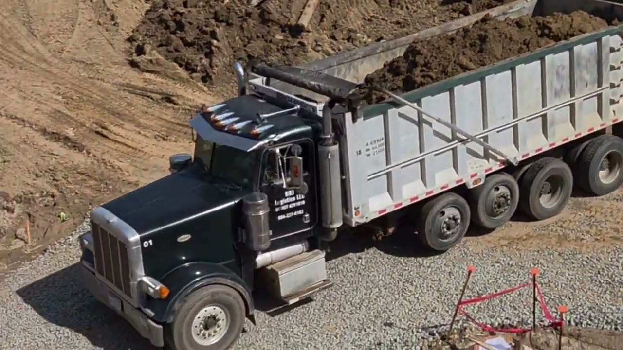 Dump Trucks clearing out dirt for next phase