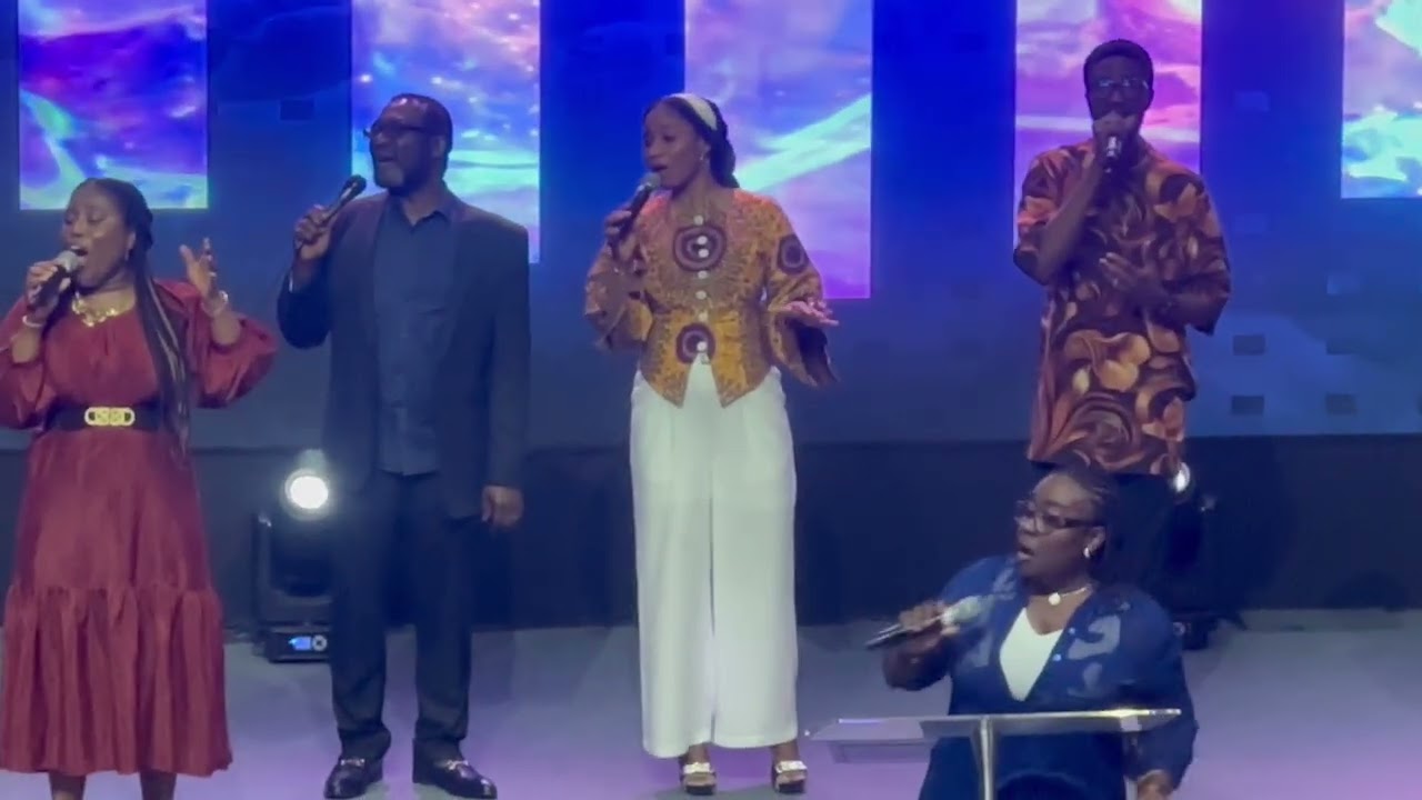 Minister Marigold leading POP in song ministration 