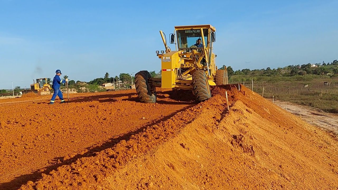 Motoniveladora caterpillar 140k trabalhando e trator valtra BH145 material com umidade boa ajuda