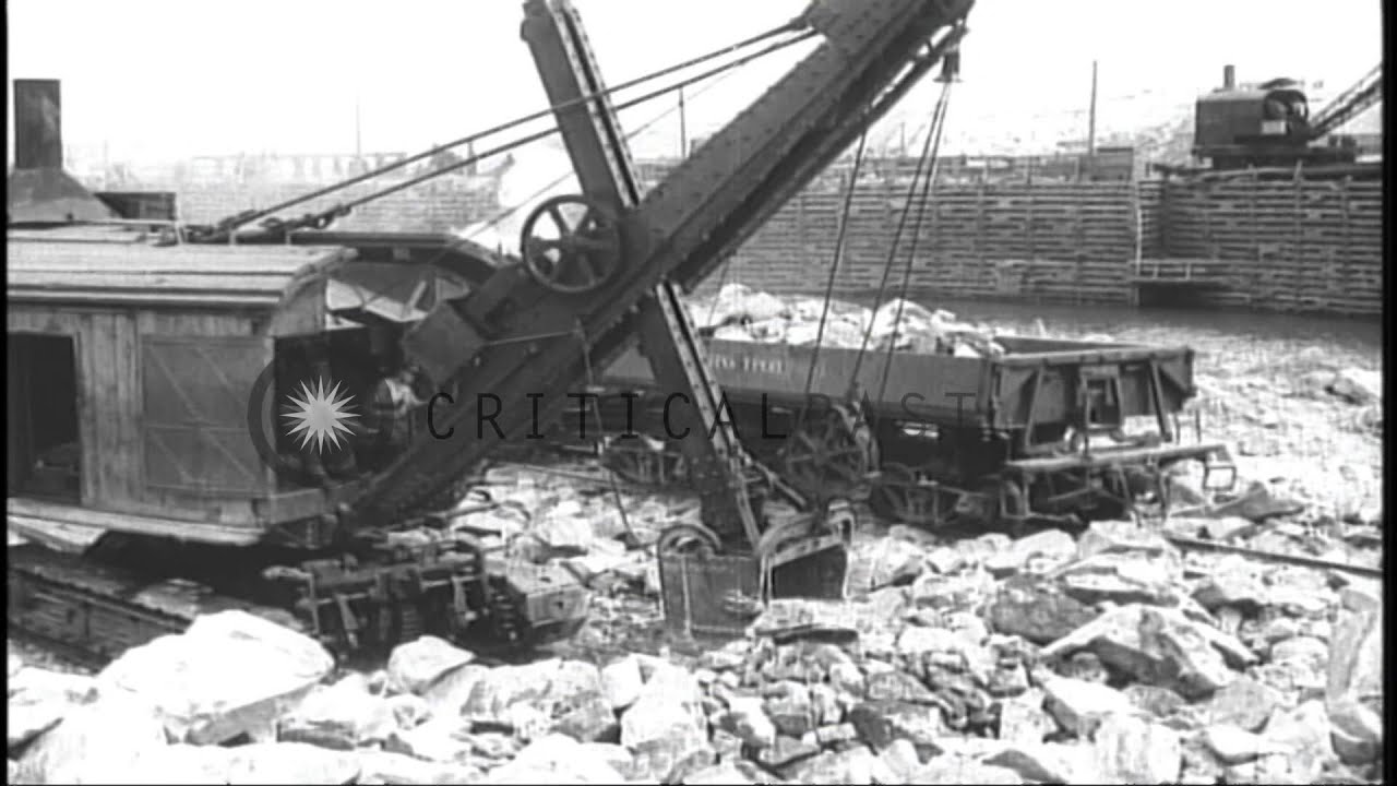 Men work to construct Lenin dam across the Dnieper River in the Ukranian Soviet S...HD Stock Footage