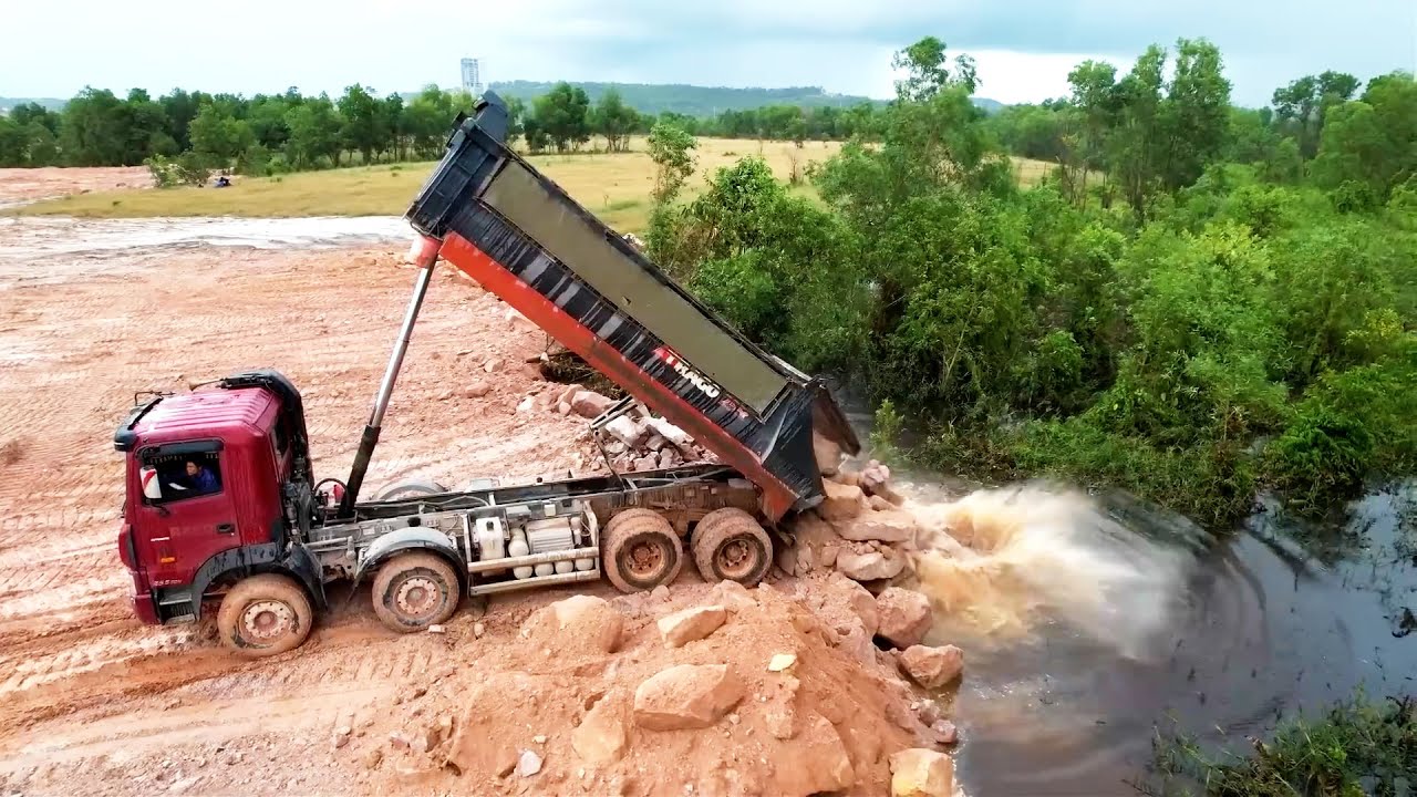 Good Activities Land Reclamation Process With 25Ton Dump Trucks Dumping Huge Stones In Low Land Area