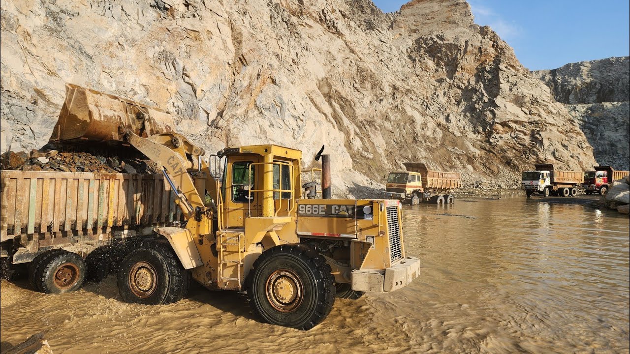 This Wheel Loader Works Like a Monster at Work Site: Caterpillar 966E Loading Rocks into Dump Trucks