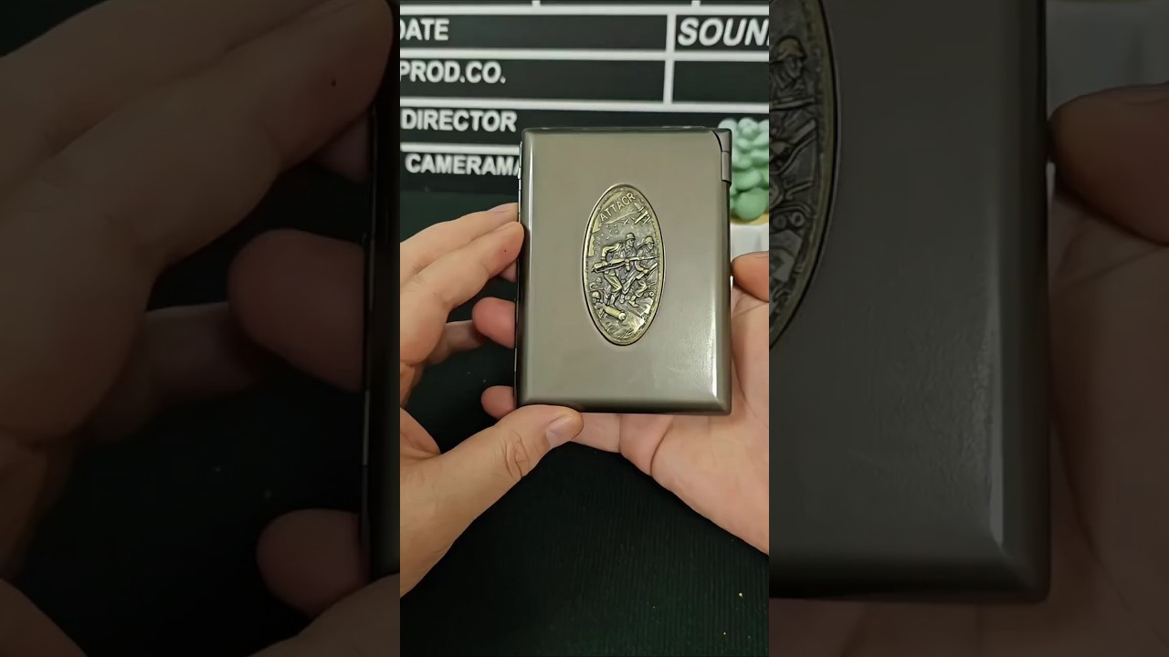 A pretty metal cigarette case with built-in metal lighter