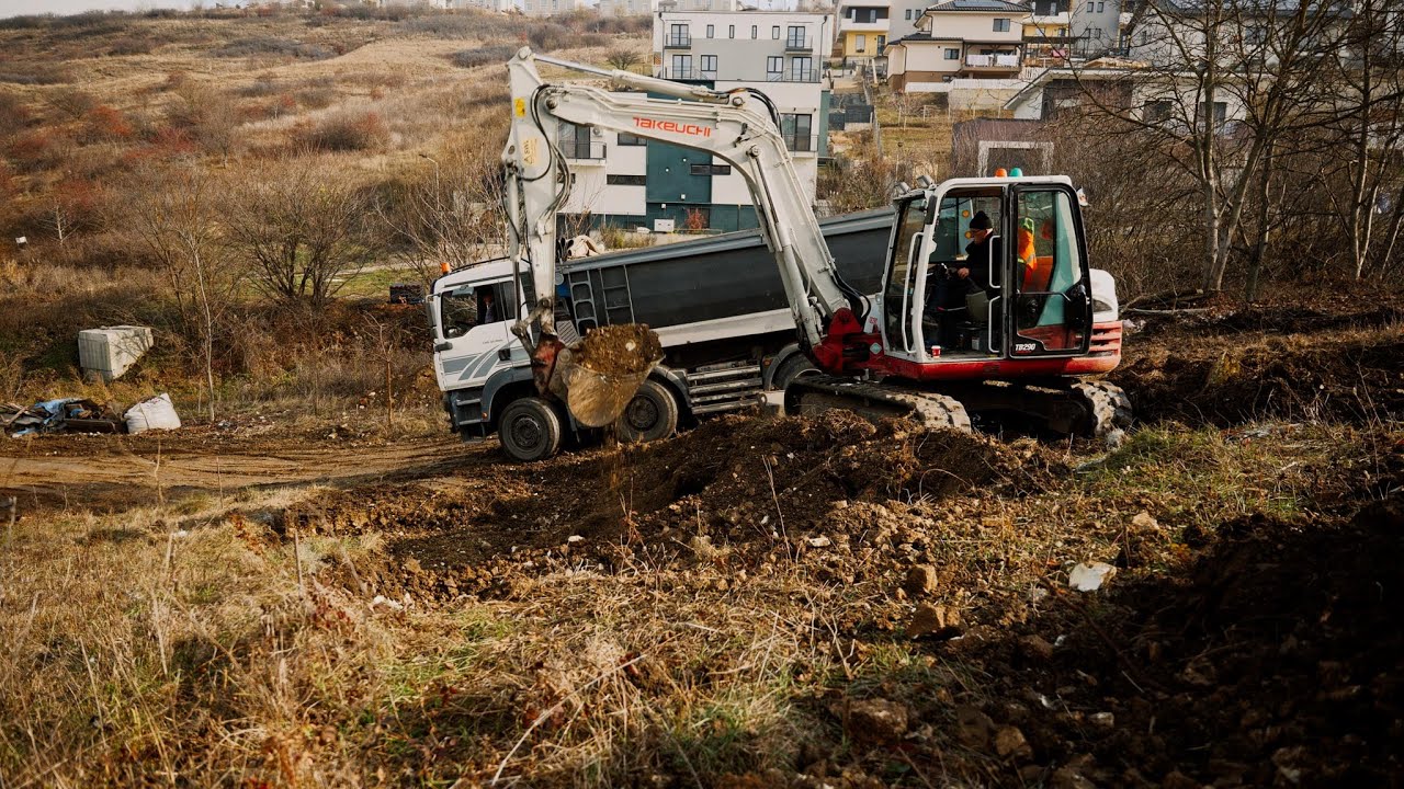 Takeuchi TB290 digging and loading a truck 4K