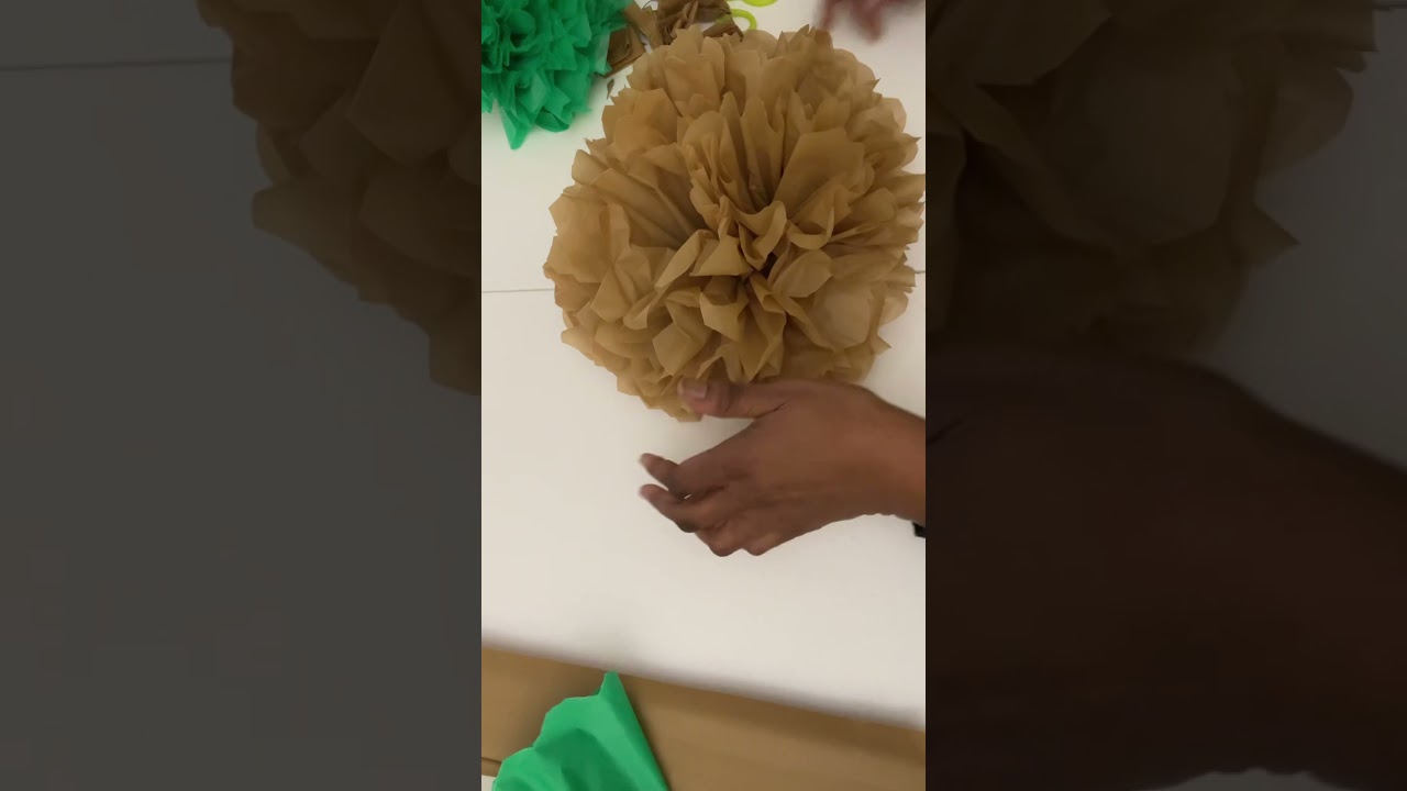 ￼ Large pom-poms decor made with plastic table covers! ￼