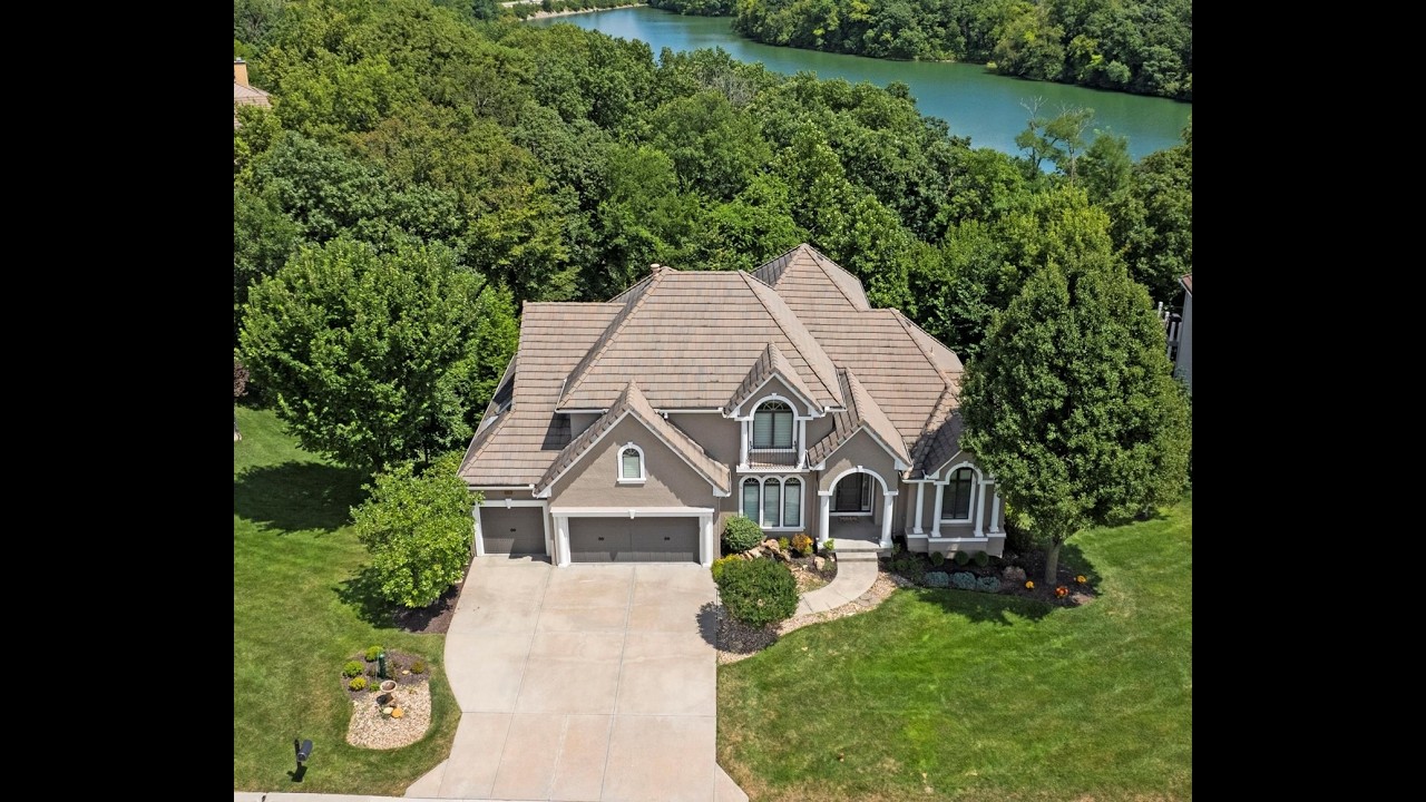 FLY THROUGH LUXURY! 8190 Shoreline Dr | Parkville, MO! LAKEFRONT & MAINTENANCE PROVIDED ESTATE!