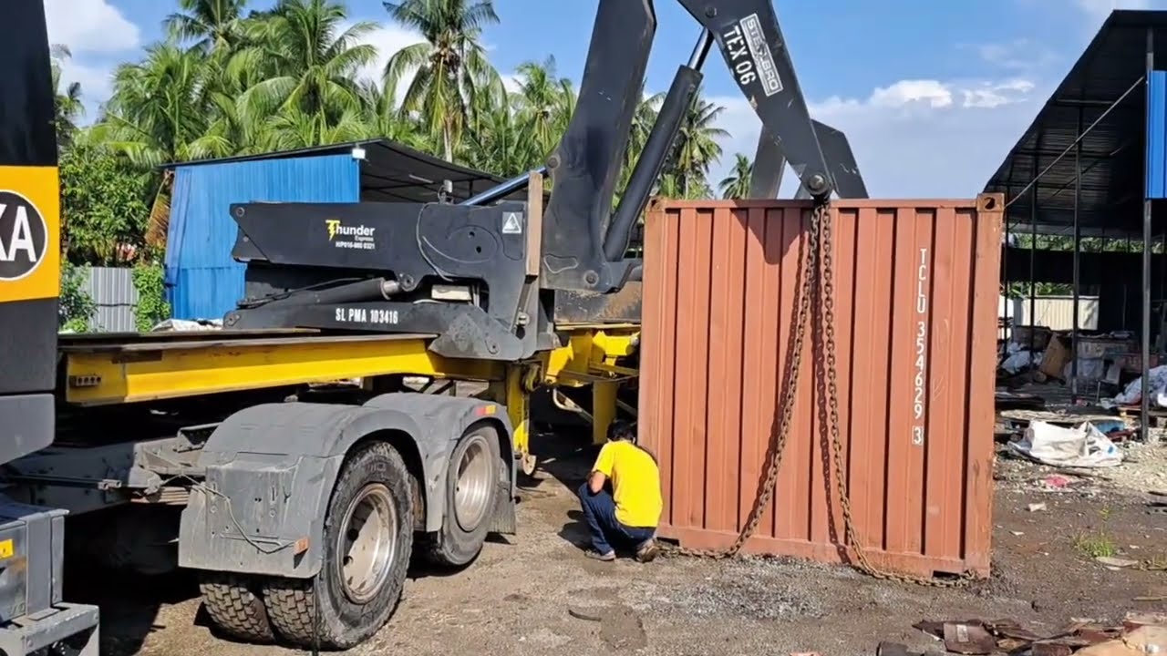 How do you lift a container and shift it to a vehicle after filling it?