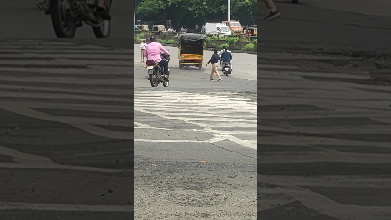 pune traffic cop following all traffic rules. crossing road while on call. 😜