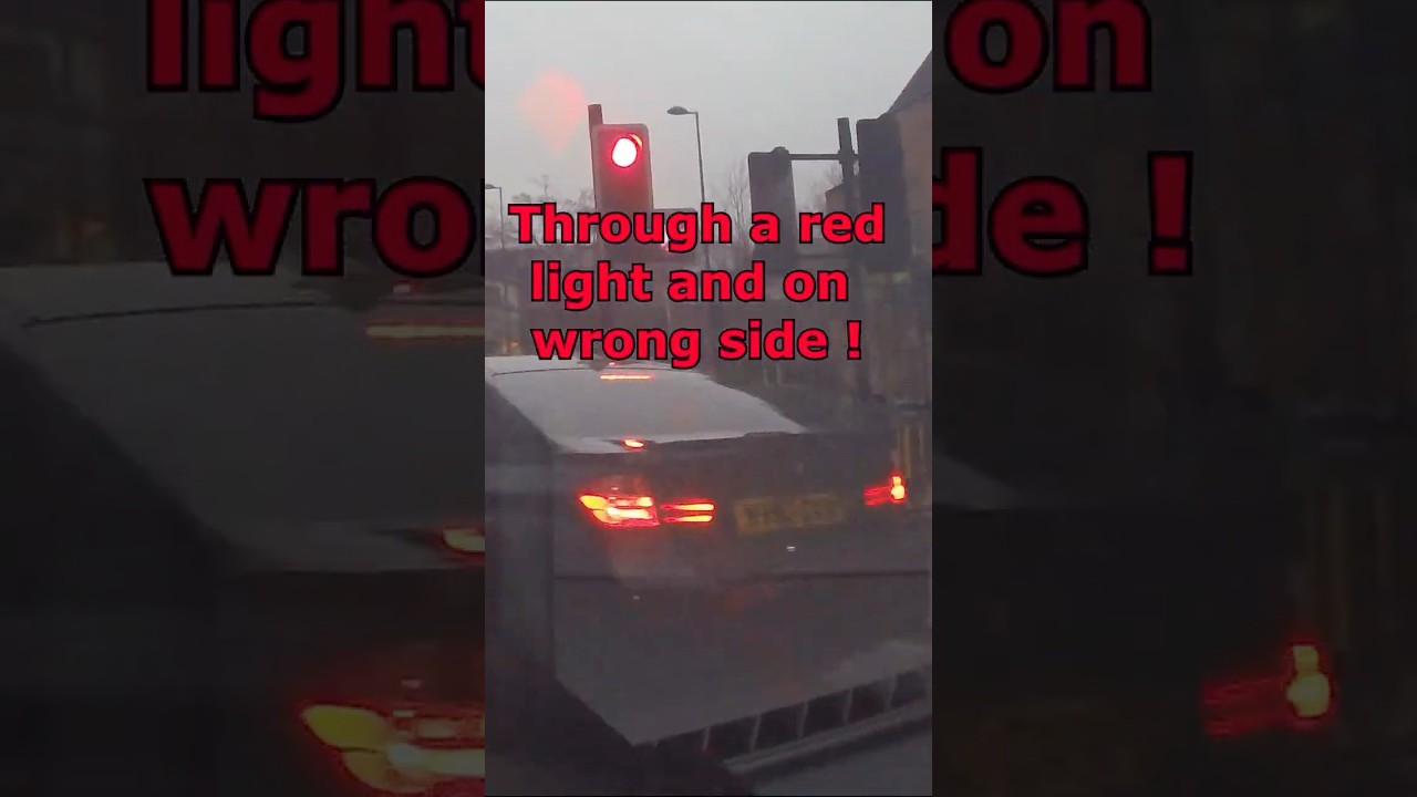 Bad driving : Speeding through a red light on wrong side of road