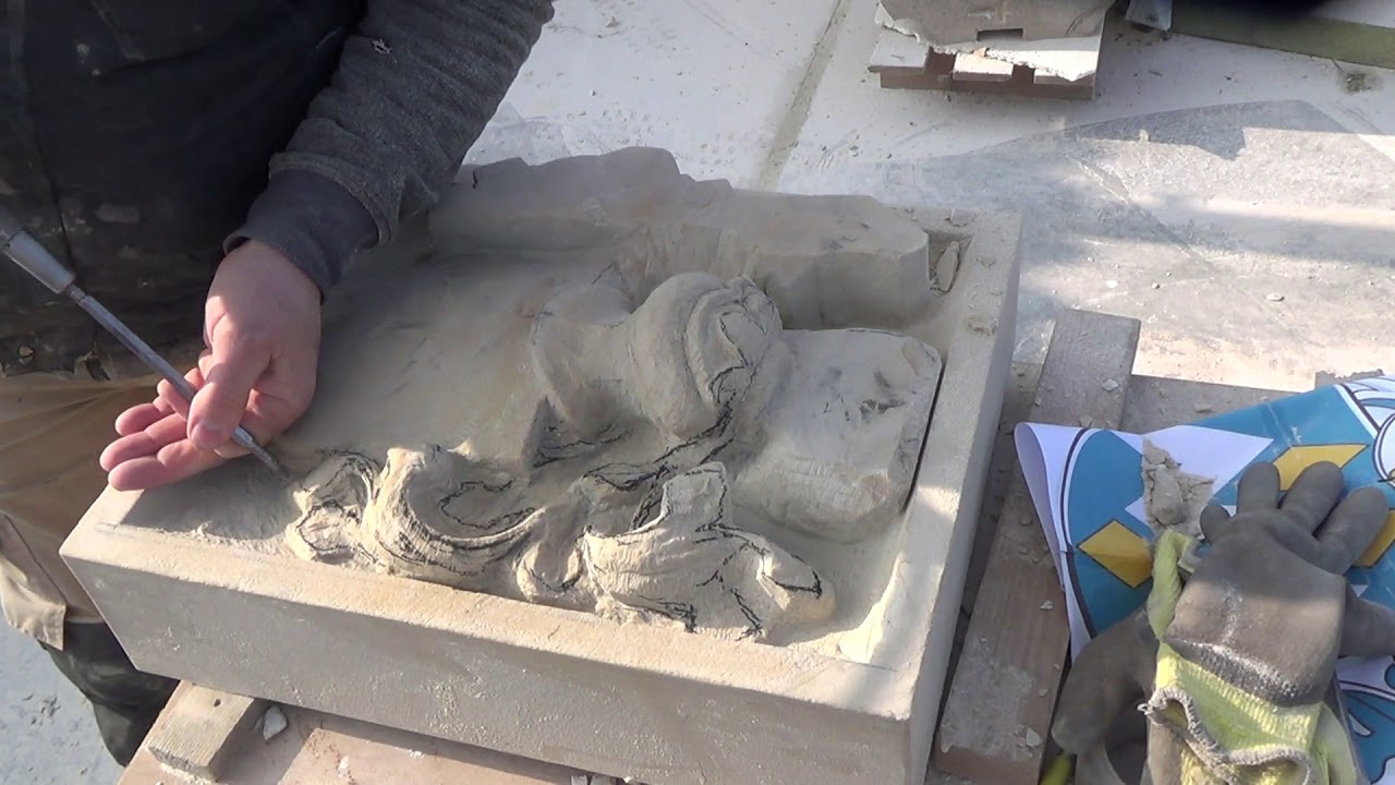 Carving a deep relief coat of arms in sandstone