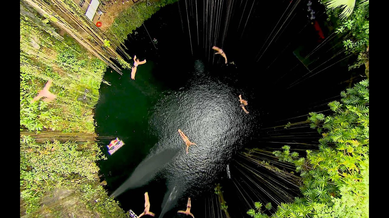 Group Cliff Dive into the Ik Kil Cenote