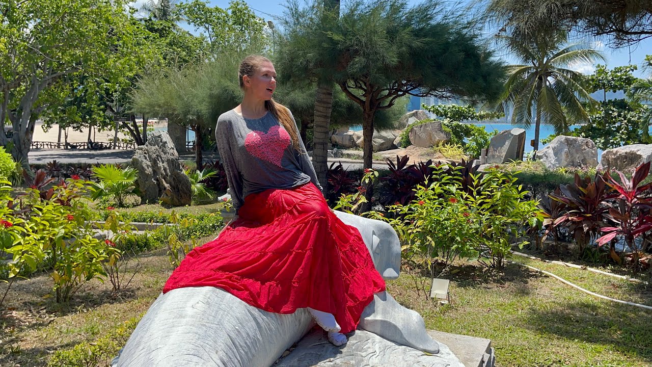 Photo shoot in the park. Long red skirt, grey sweatshirt, white socks. Wet clothes.