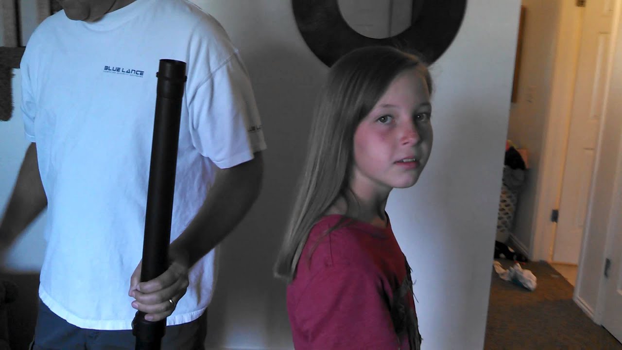 Dad puts daughters hair in a pony tail using a vacuum