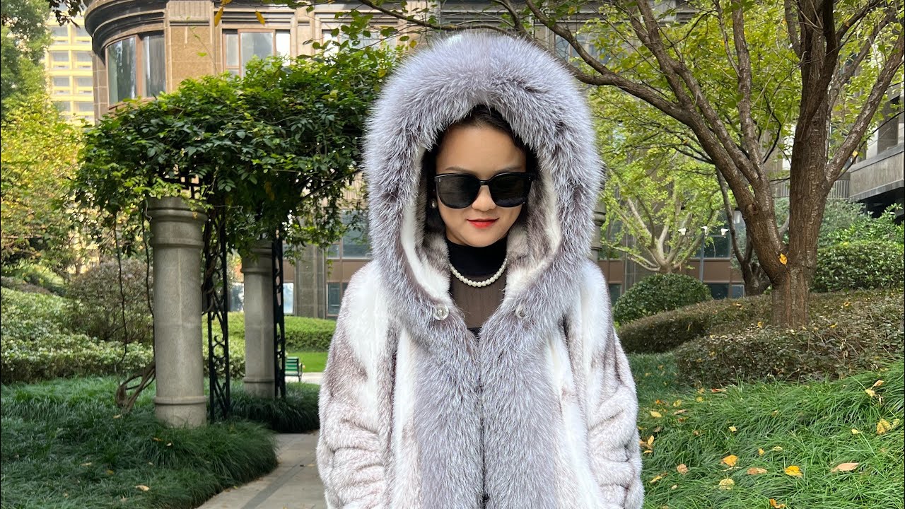Luxury mink fur coat with hood and silver fox trim.