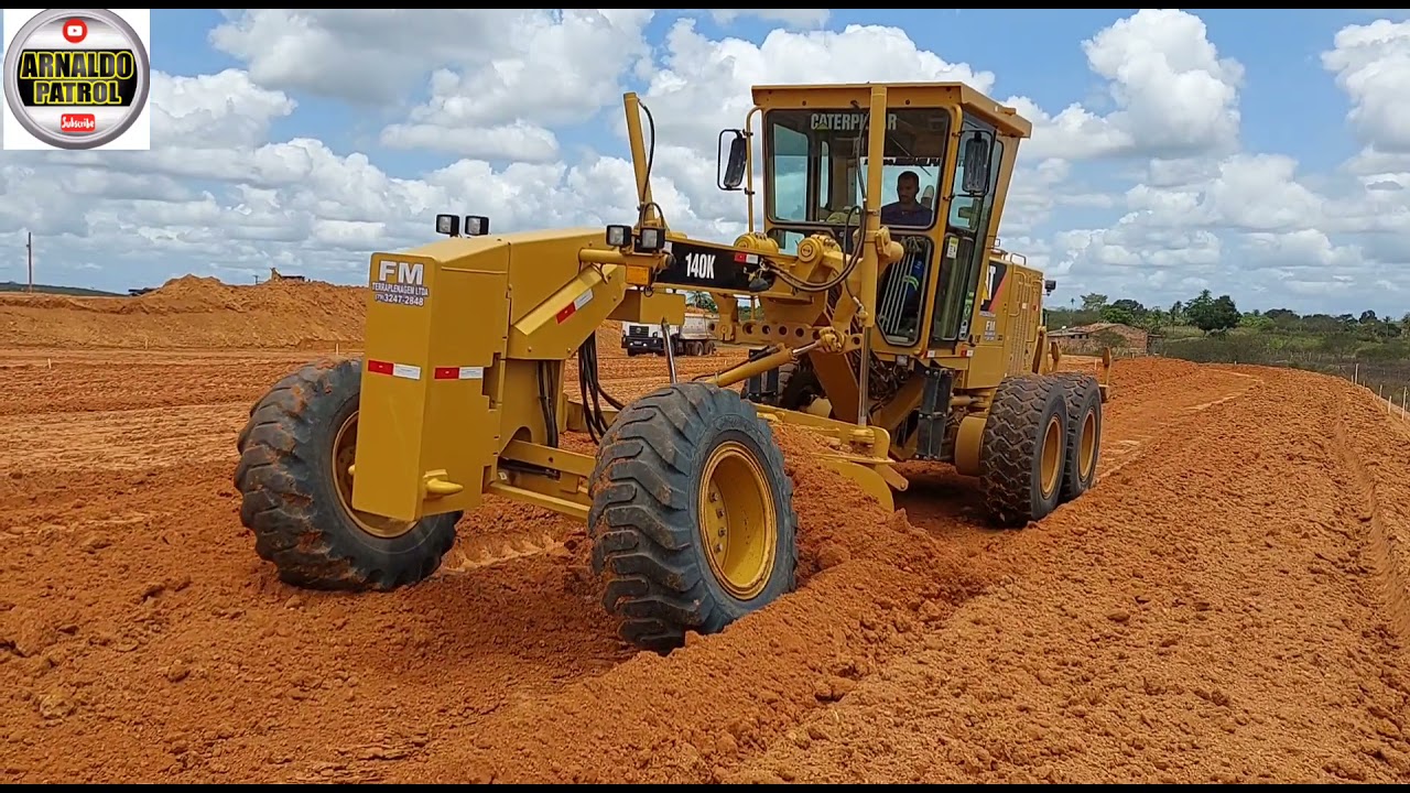 Motoniveladora caterpillar 140k trabalhando em terraplanagem e trator valtra BH145