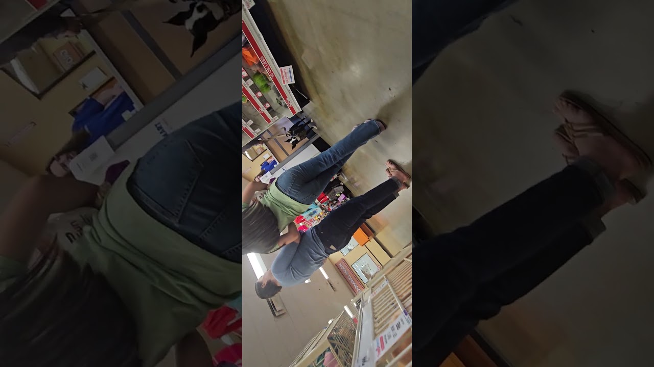 Pretty mom at pet store with sandals showing feet. 