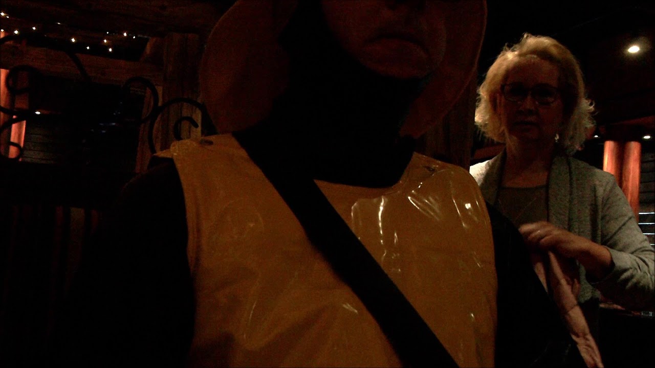 drink in a bar in black rubber and shiny yellow rainwear