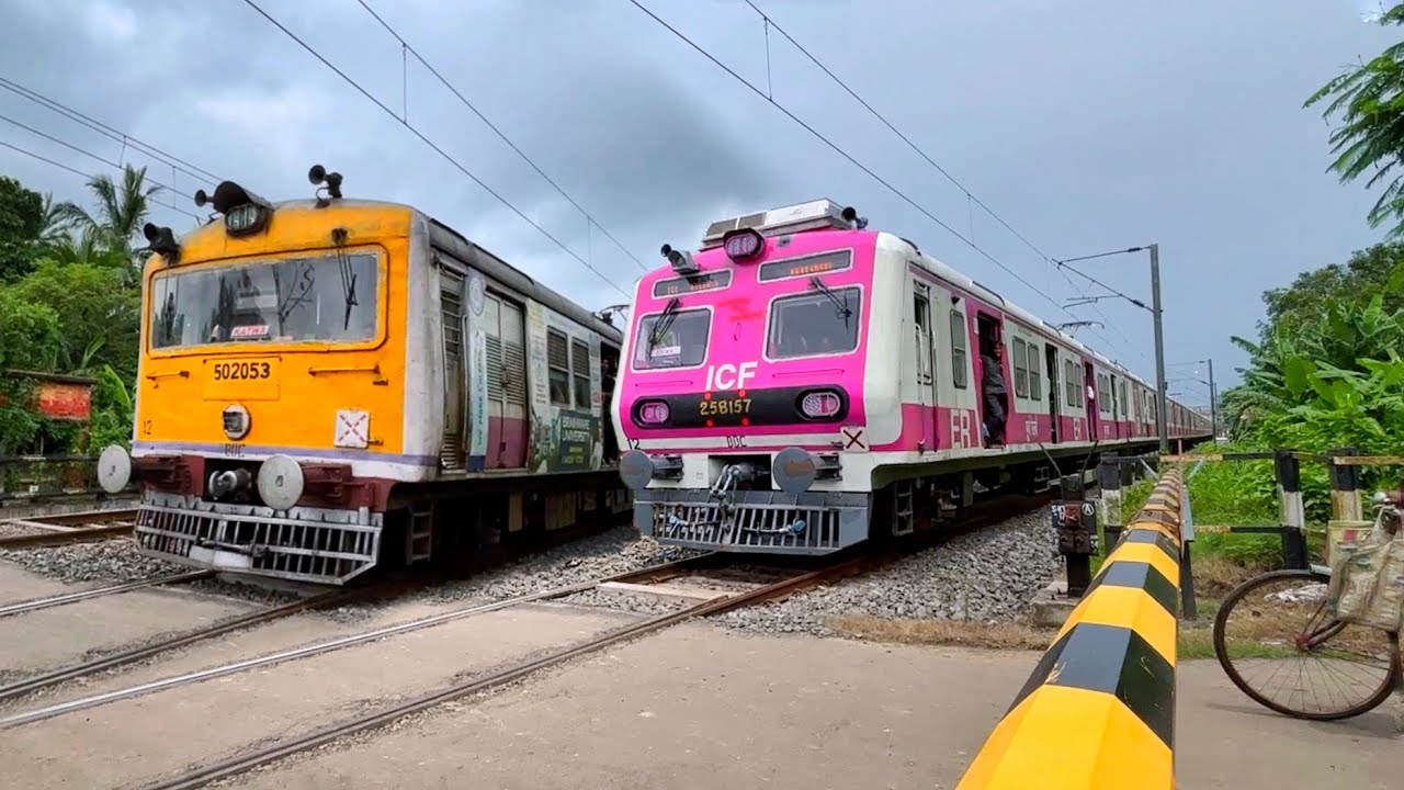Different model EMU local trains Dangerously skipping throughout level crossing railgate.