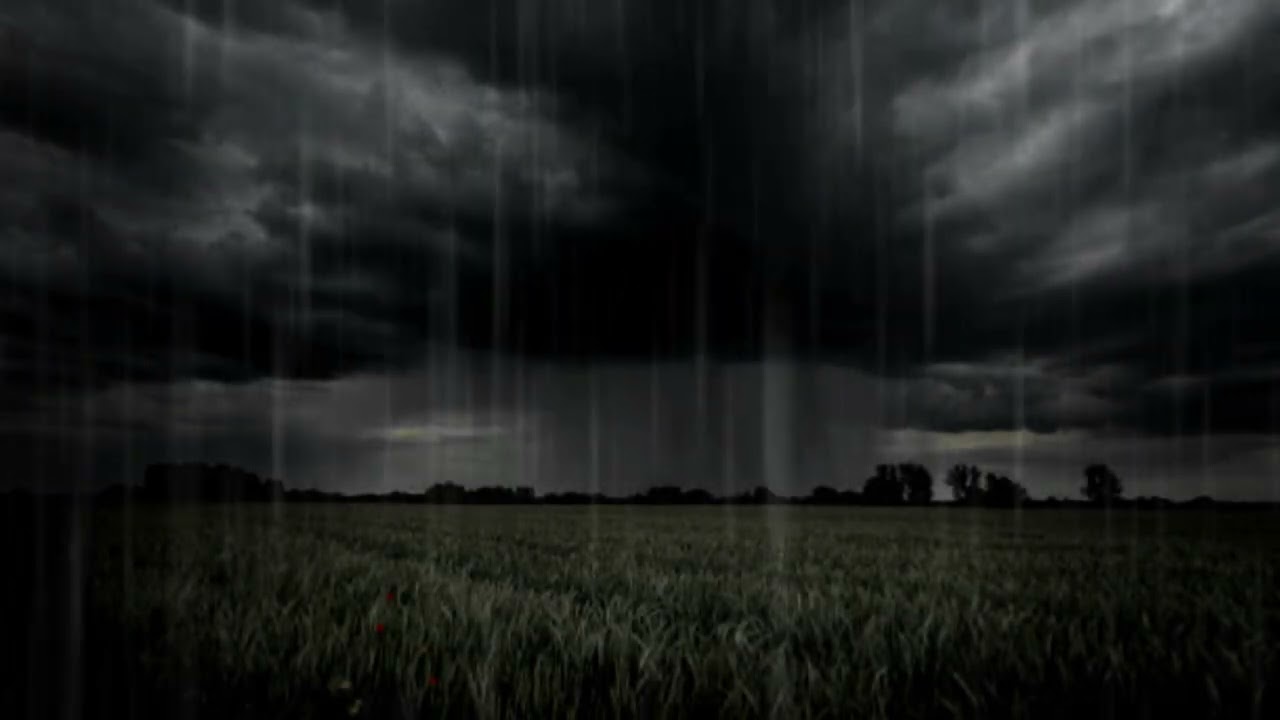 Dark clouds with rain at plain grass
