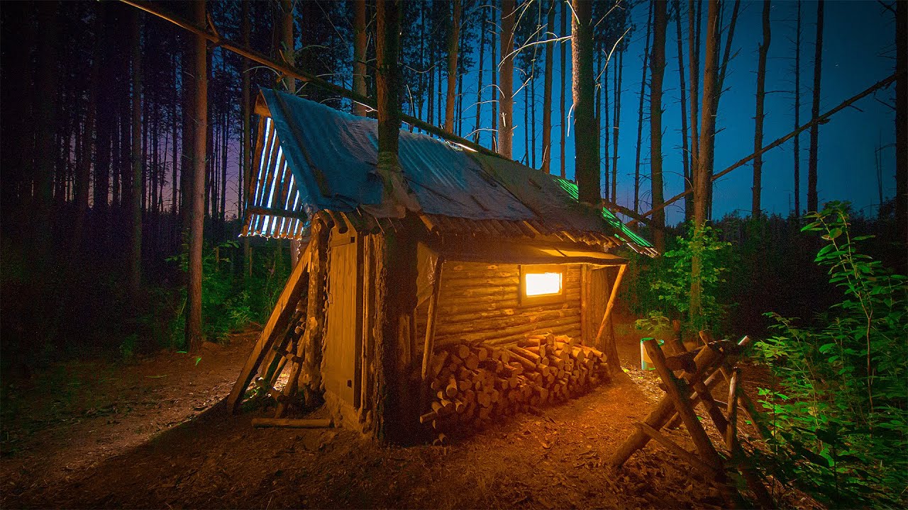 Night in my log cabin in the wild forest. I bring comfort and order in the forest house.
