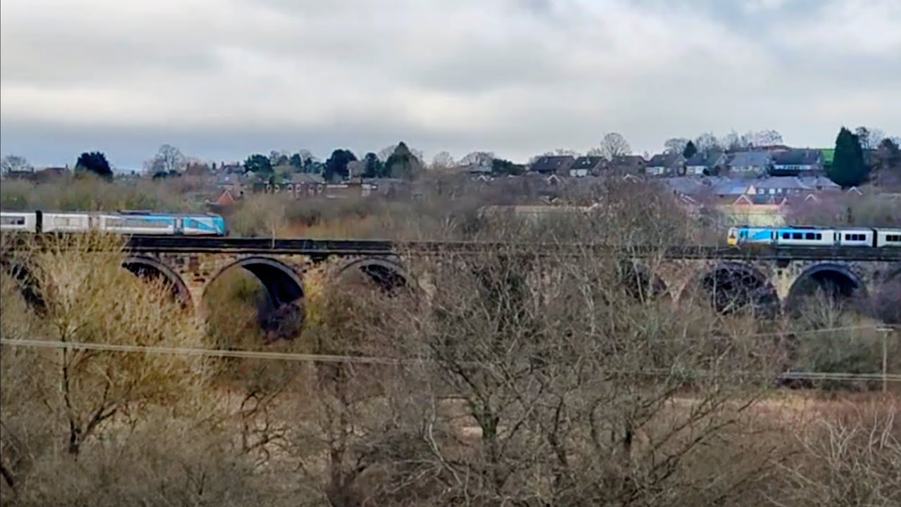 Two TPE 185s crossover on the Midland Railway Viaduct, New Mills