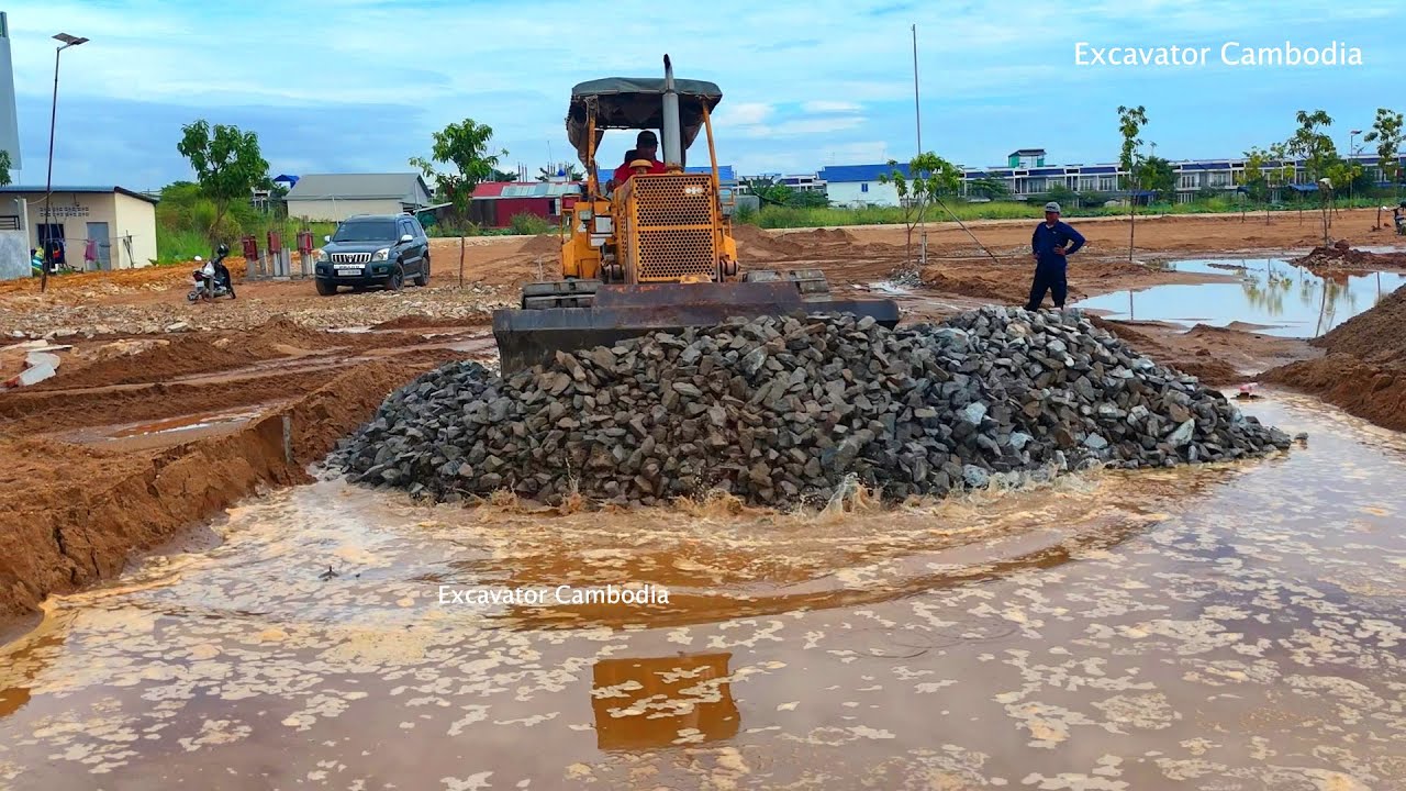 Good Komatsu Dozer D30P Pushing Gravel Making Foundation Road And Dump Truck Unloading Gravel