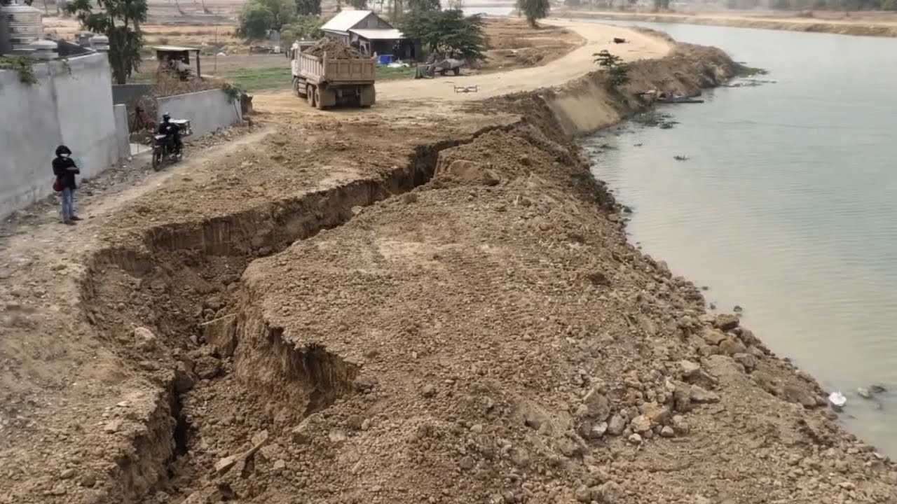 Dump Trucks and Dozer Bury Big Crack On The Land 