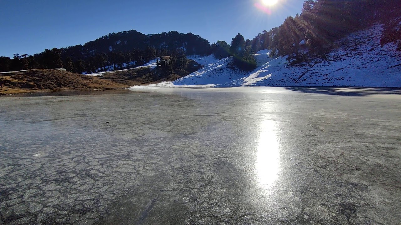 Testing the ice of the frozen Masar Tal lake near Budha Kedar