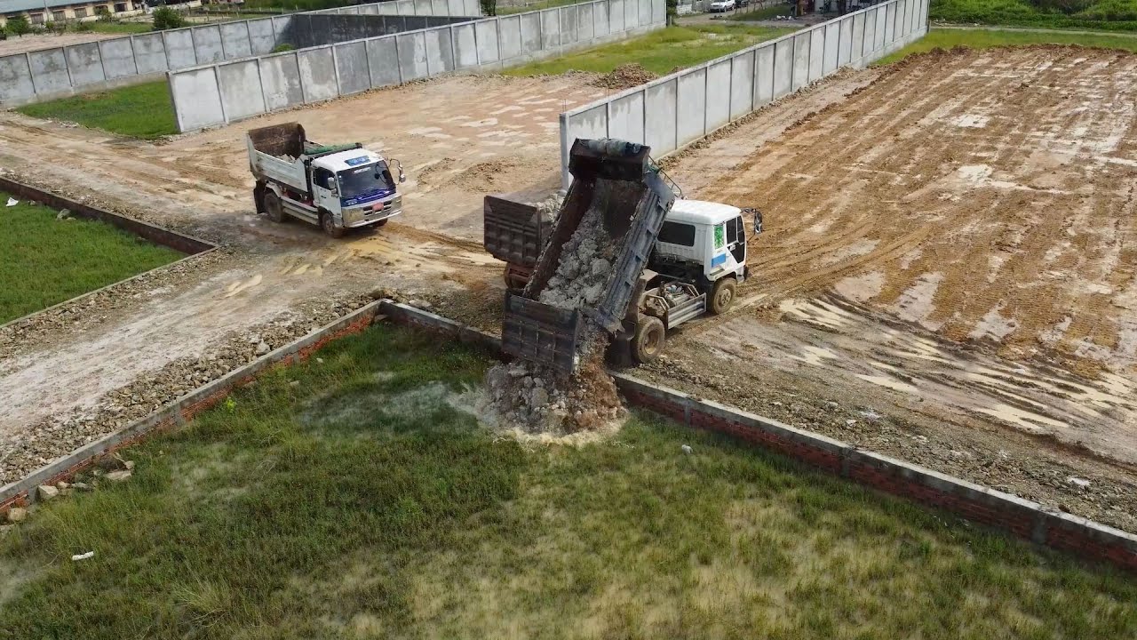 Wonderful By Komatsu D20p Dozer Push the soil into the water With Dump trucks Land transport