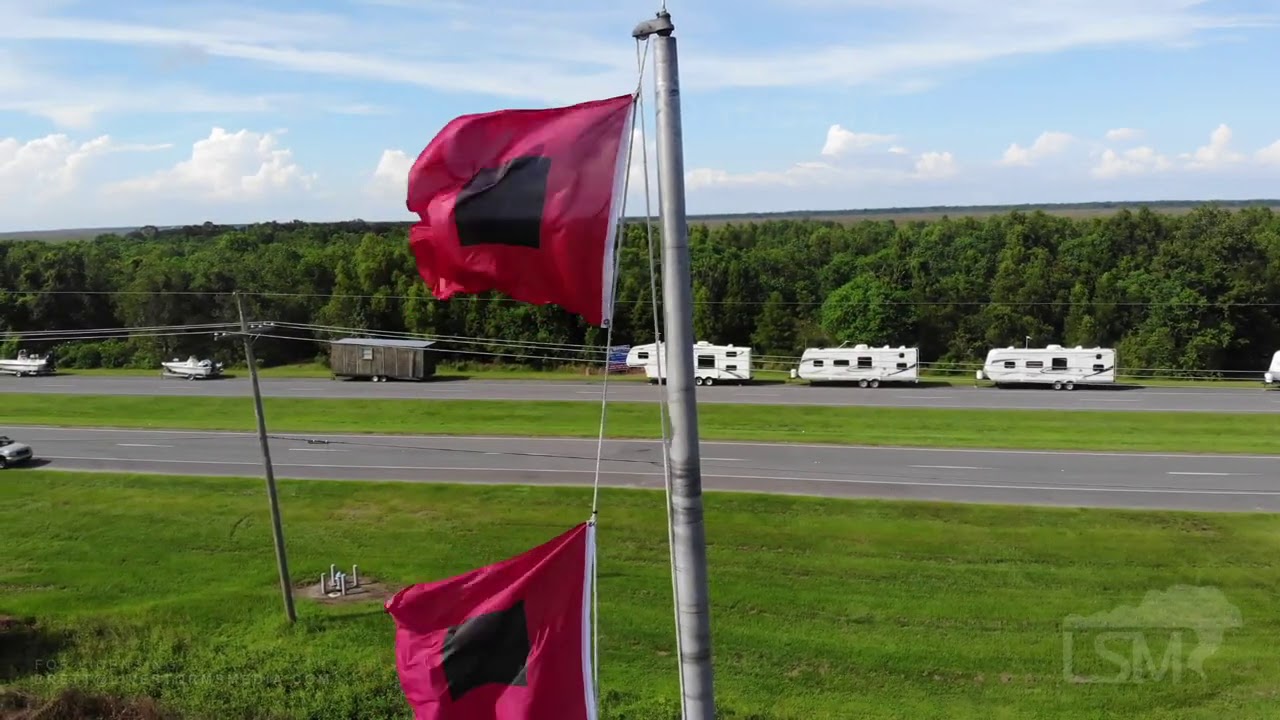 09-13-2020 Reggio, LA - Double Hurricane Flags Fly Over Lines of Vehicles Sheltering From Sally - Dr