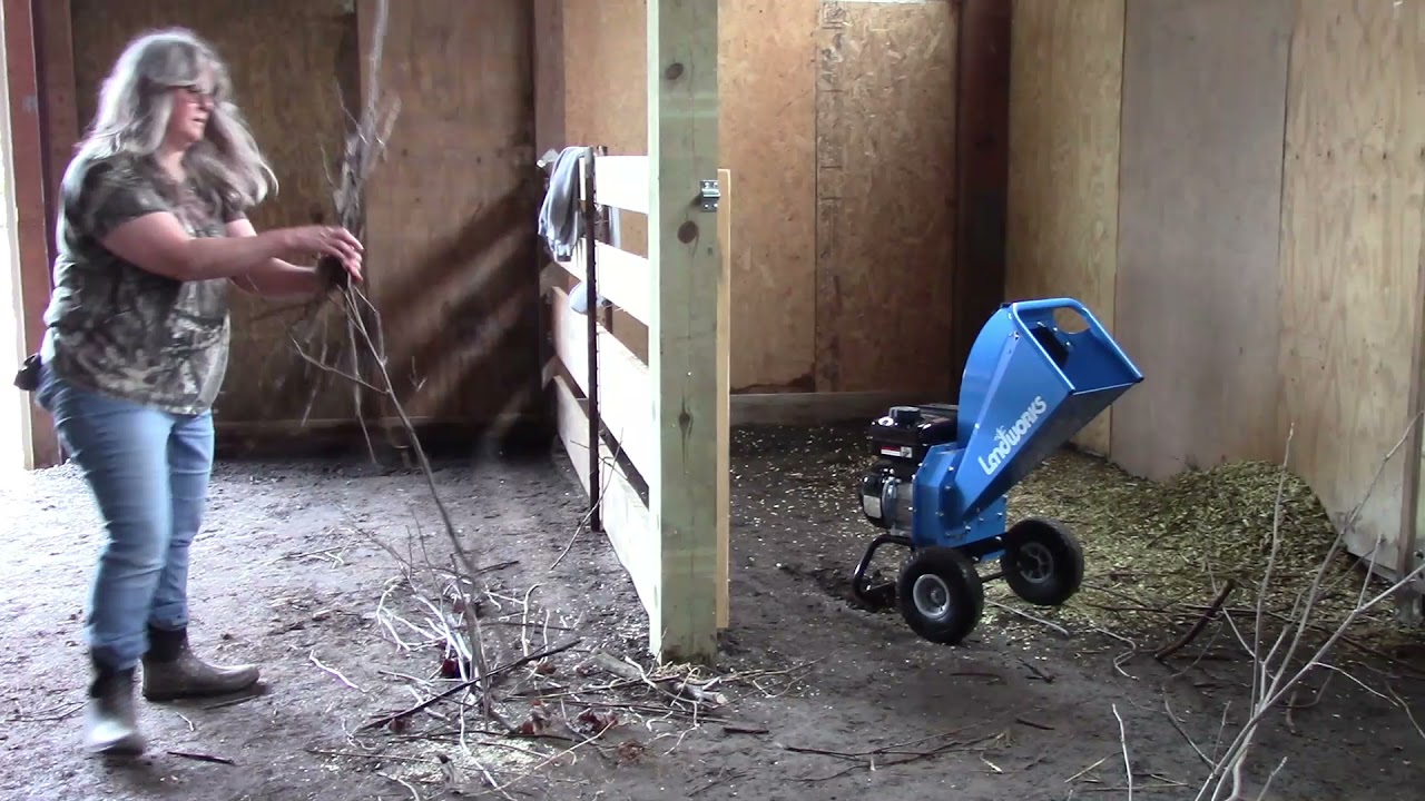 Chipping small branches to make bedding for animals