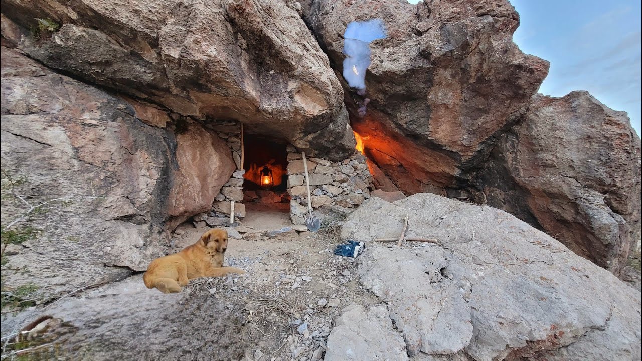 Rebuilding a rock cave: a safe haven with a fireplace and a stone defensive wall