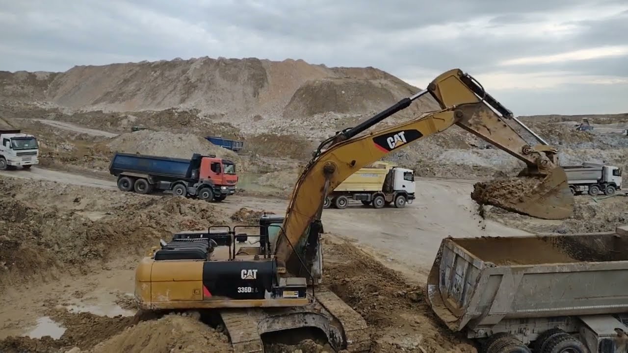 Machines Work Channel , Caterpillar 336 Excavator Loading trucks with  the mud ground , Clay Quarry