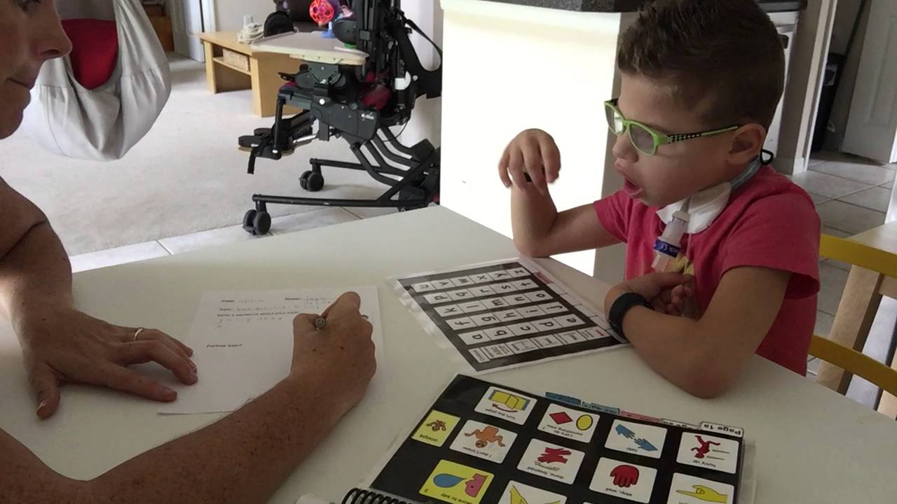 Jayden writing and talking with PODD