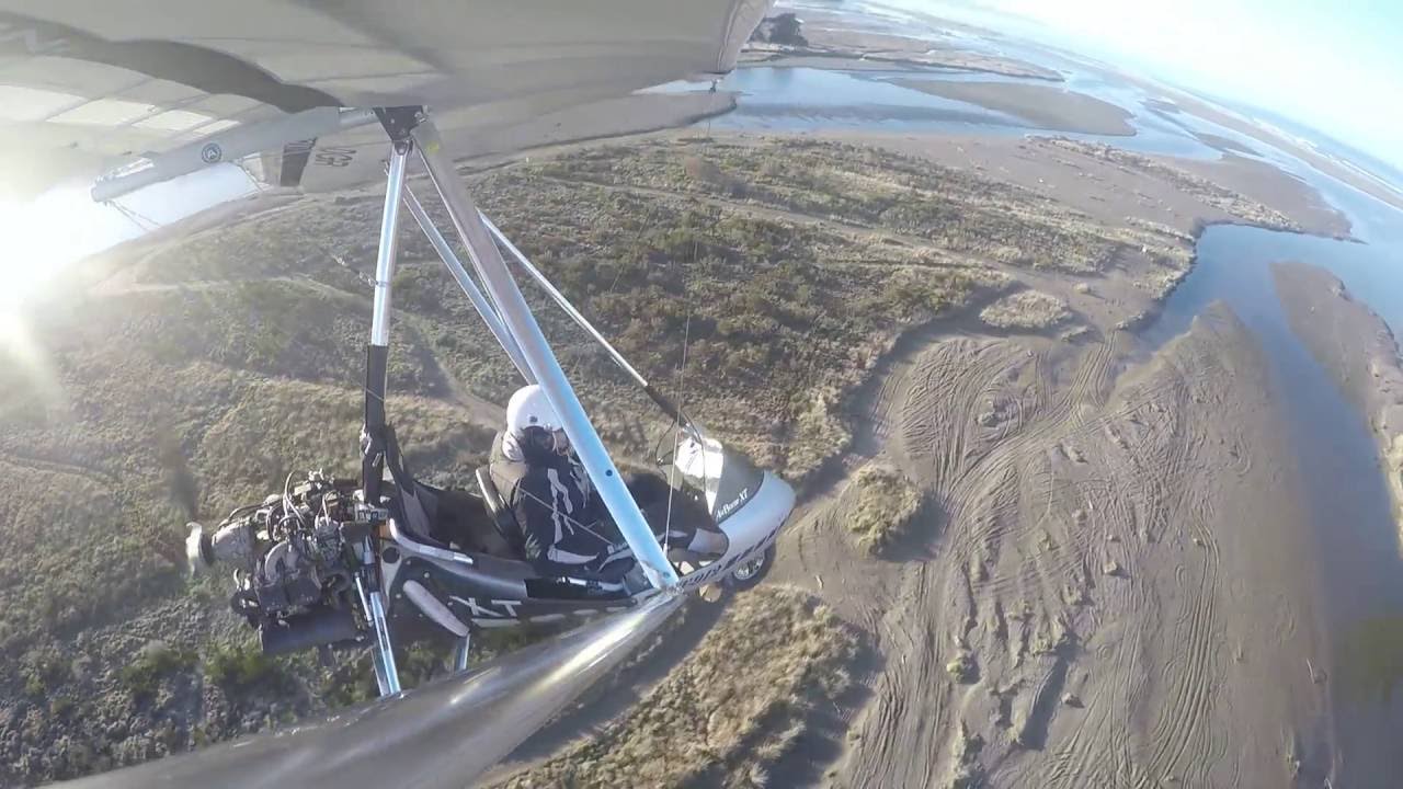 Microlight trike beach flight.