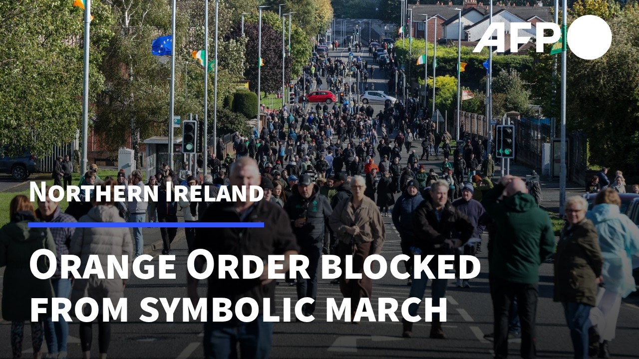 People gather blocking Protestant Orange Order march due to pass through mainly Catholic area | AFP