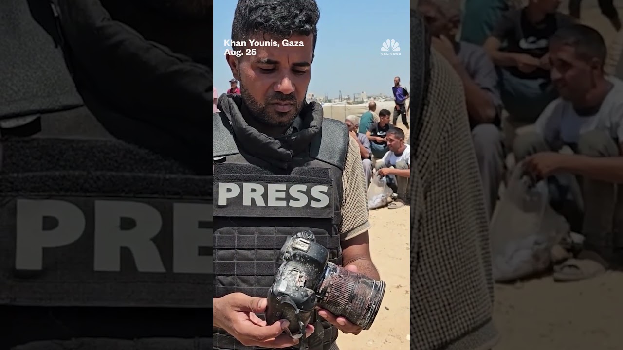 Gaza journalist holds the blood-soaked camera of a colleague killed in an Israeli strike