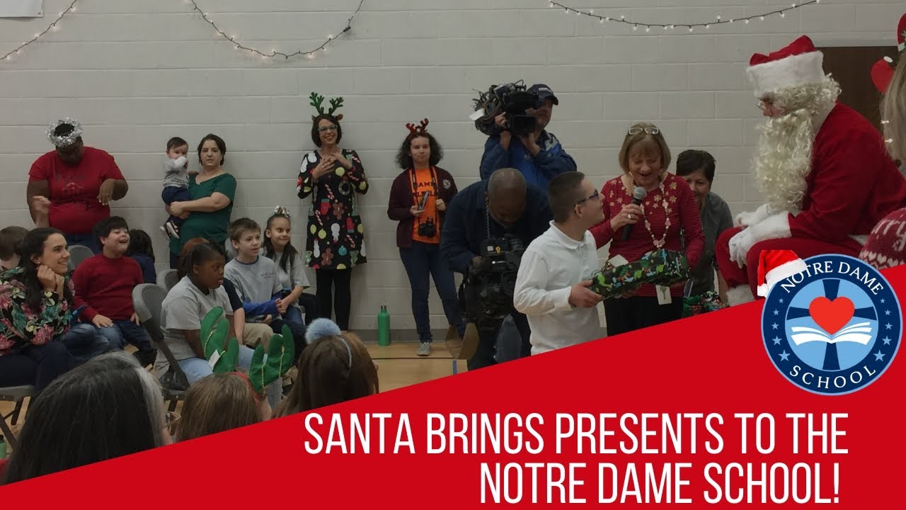 Santa Claus Gives Gifts to the Students of Notre Dame School!