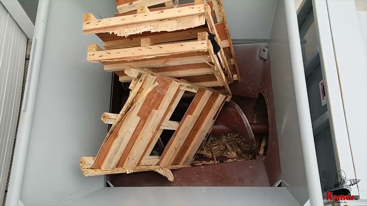 Komar Auger Compactor Shredding and Compacting Pallets