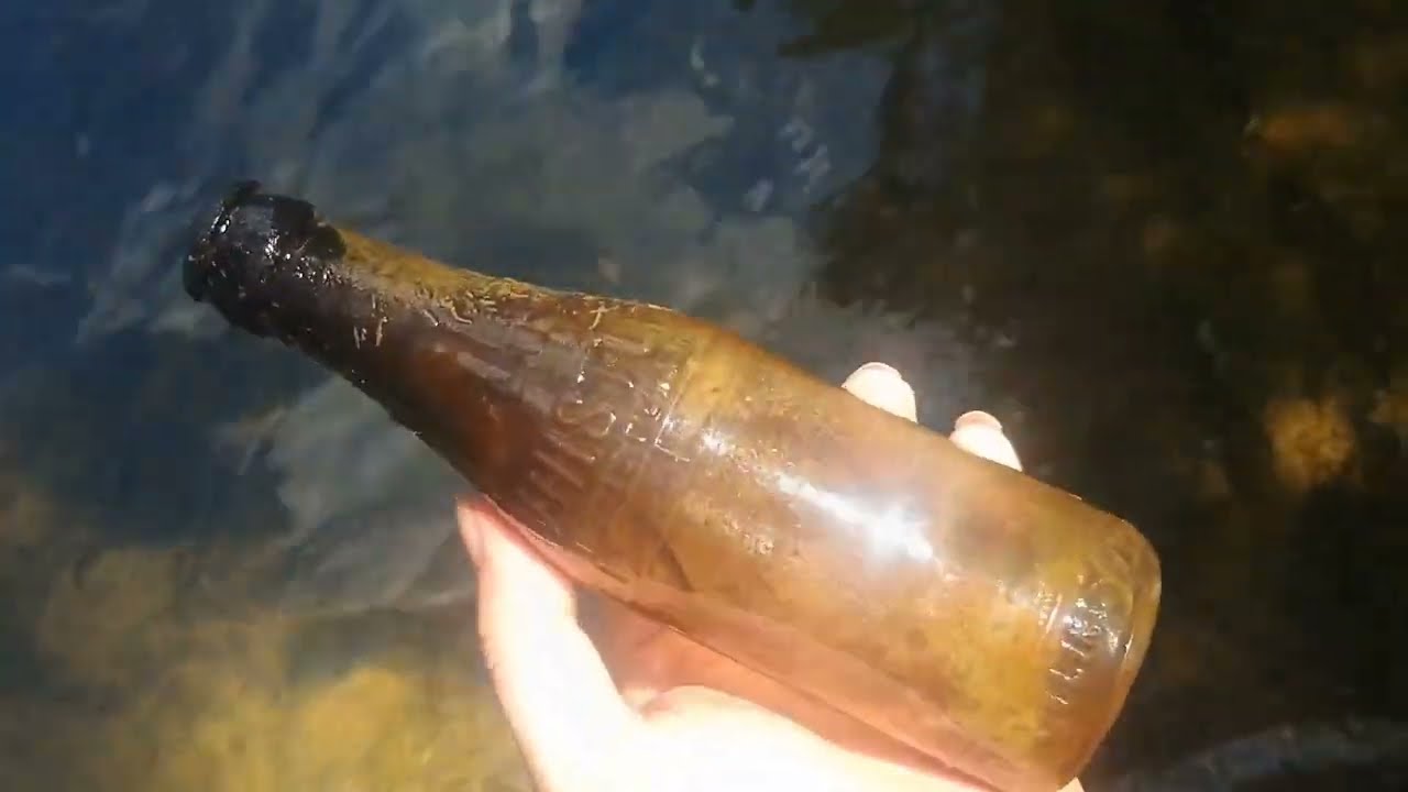 Small creek has a surprising number of bottles in it.